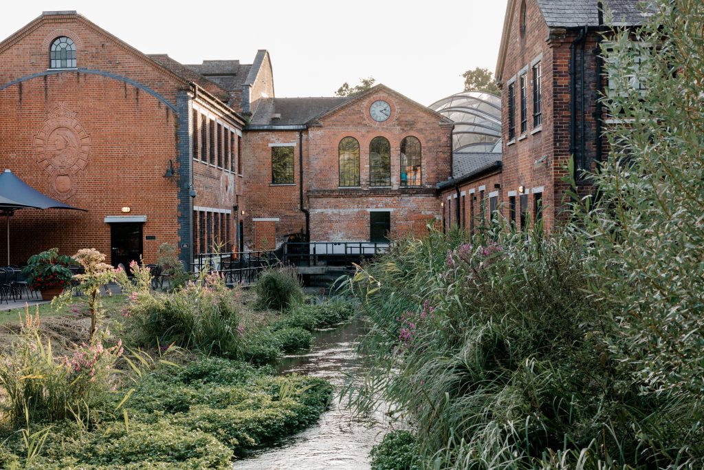 Elegant wedding at the Bombay Sapphire Distillery with unique touches like a karaoke room, Krispy Kreme donuts, and Bombay Sapphire gin cocktails.