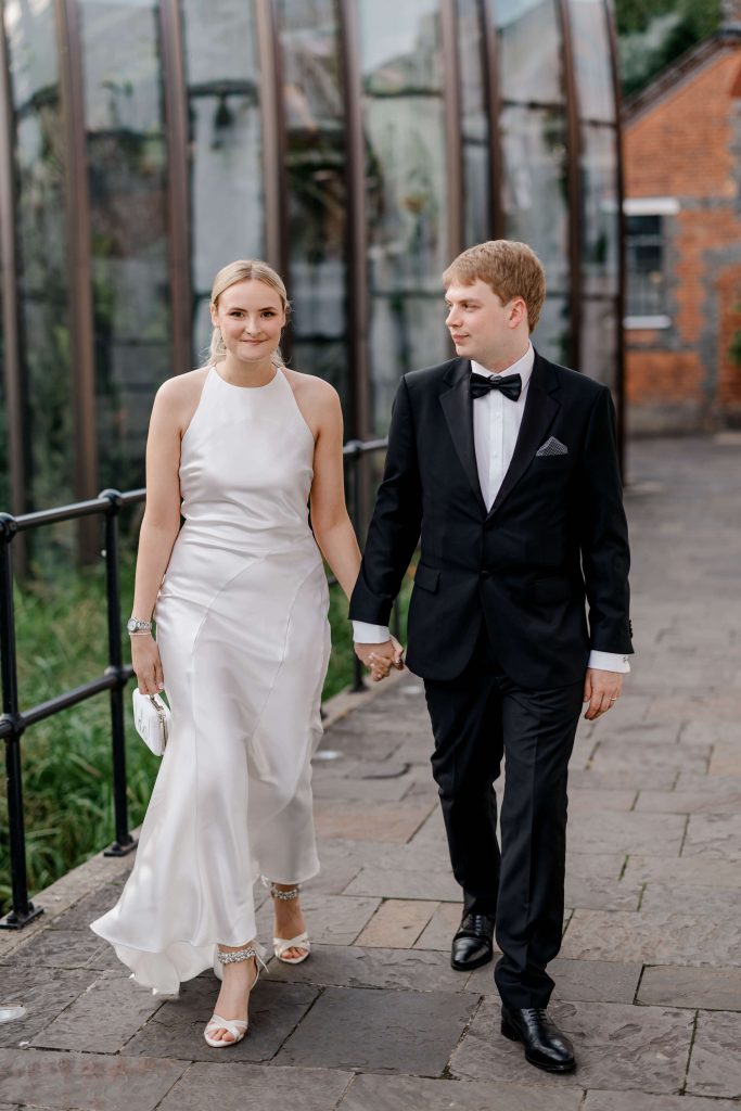 Elegant wedding at the Bombay Sapphire Distillery with unique touches like a karaoke room, Krispy Kreme donuts, and Bombay Sapphire gin cocktails.