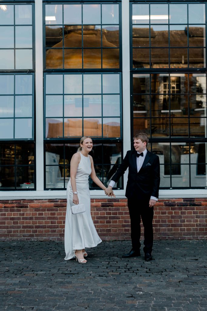 Elegant wedding at the Bombay Sapphire Distillery with unique touches like a karaoke room, Krispy Kreme donuts, and Bombay Sapphire gin cocktails.