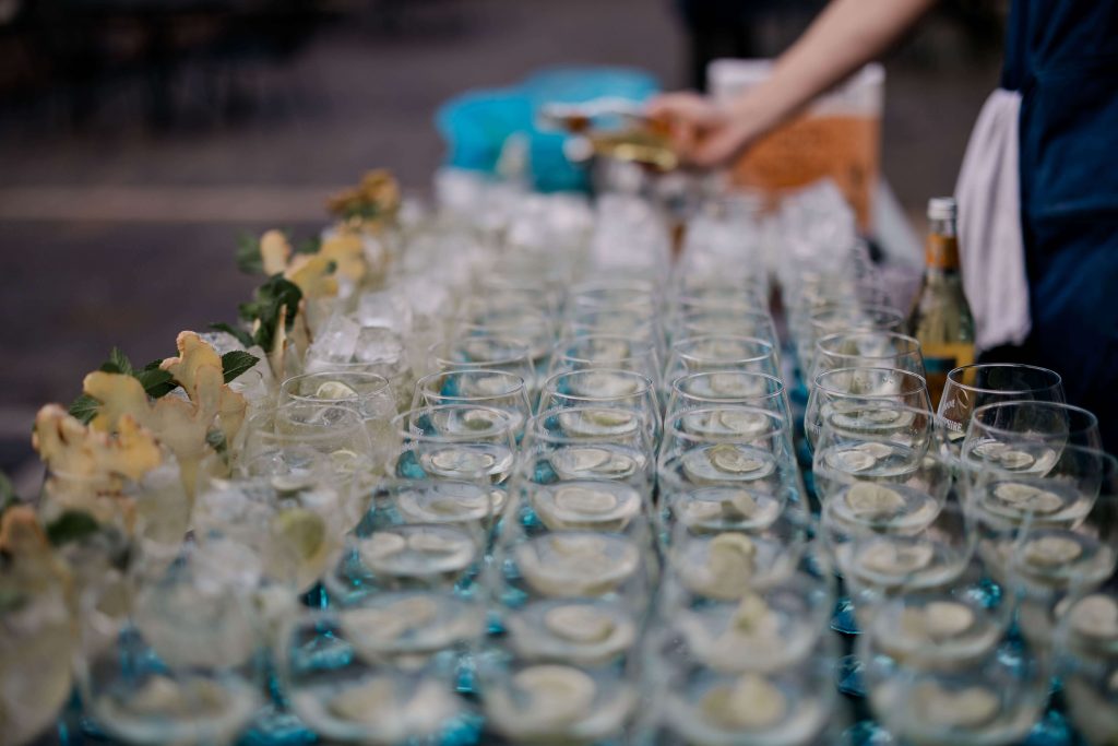 Elegant wedding at the Bombay Sapphire Distillery with unique touches like a karaoke room, Krispy Kreme donuts, and Bombay Sapphire gin cocktails.