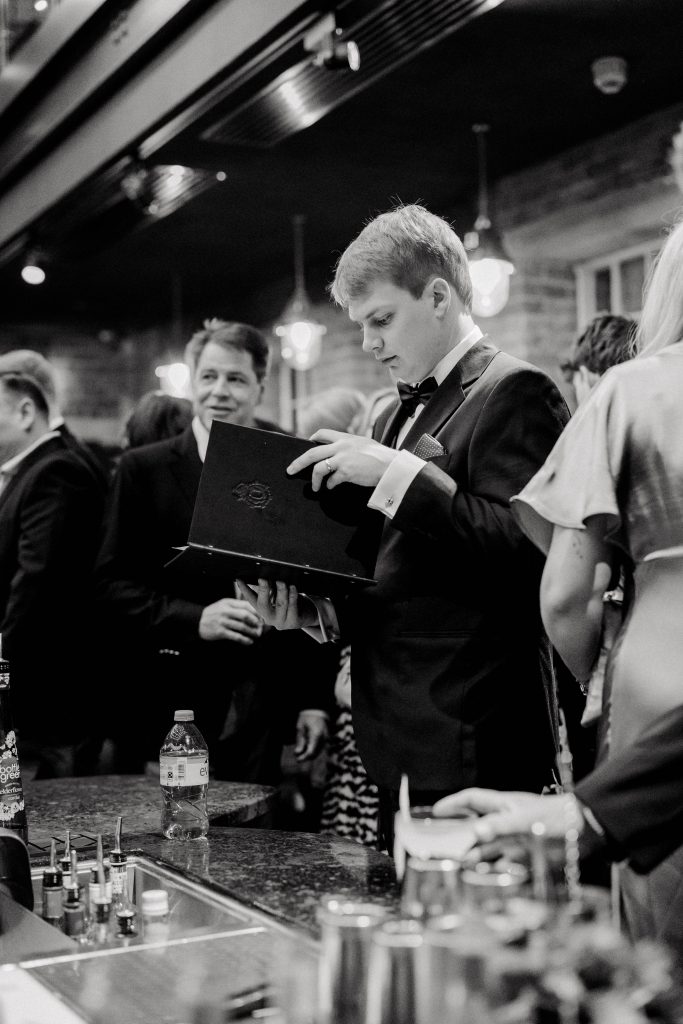 Elegant wedding at the Bombay Sapphire Distillery with unique touches like a karaoke room, Krispy Kreme donuts, and Bombay Sapphire gin cocktails.